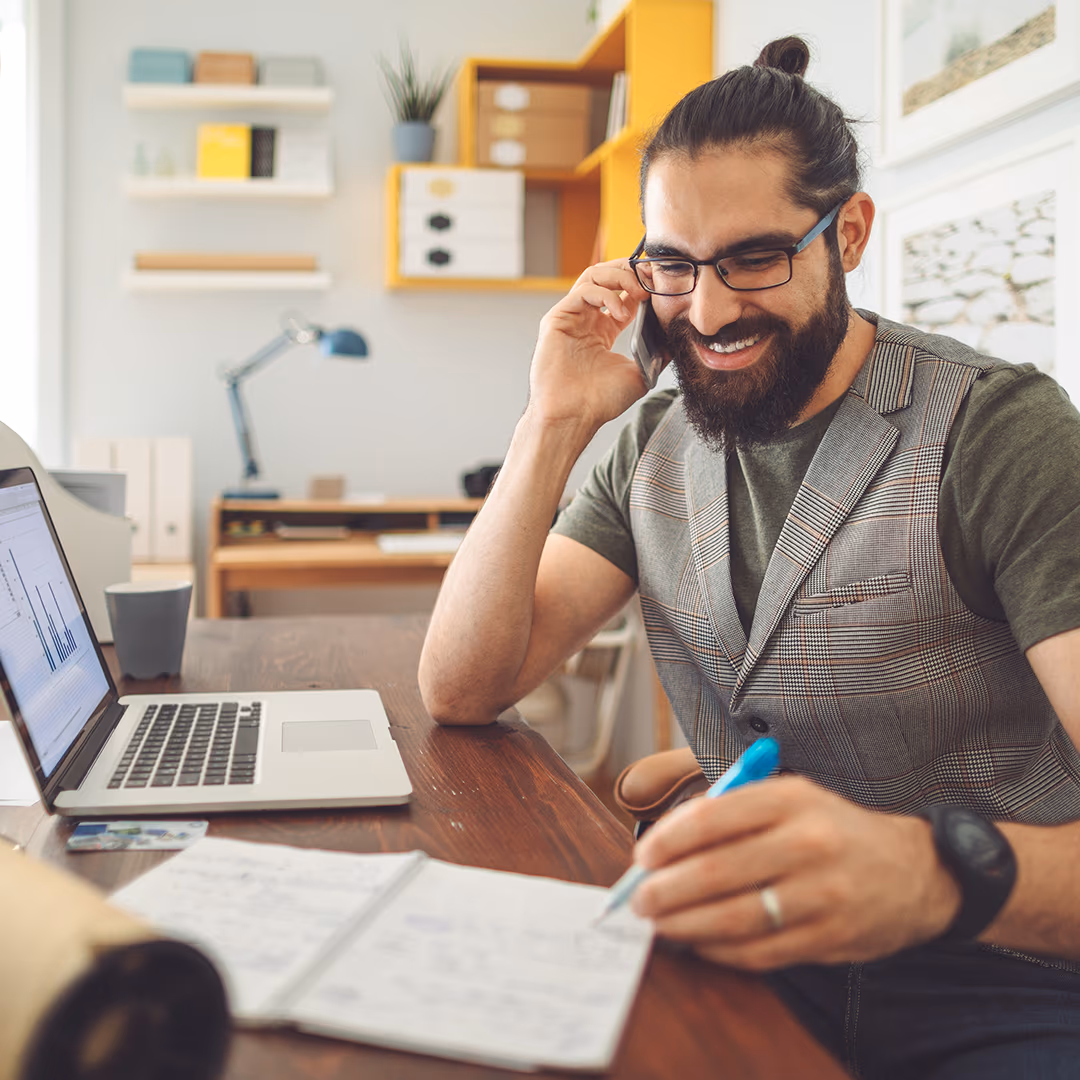 Small-business entrepreneur on a phone call at a home office, the in-market audience the campaign captured